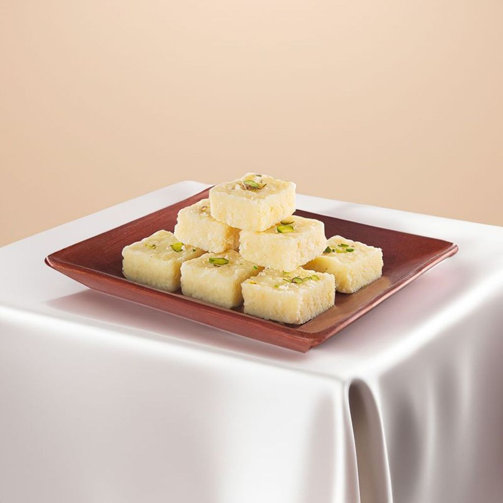 white kalakand with pistachio topping served on a tray
