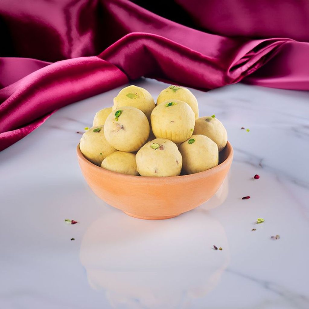 Besan Laddu dessert showcasing a classic North Indian sweet with a rich golden hue and a dusting of aromatic spices.