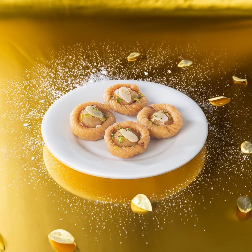 Chandrakala Indian sweet showcasing an intricate design with a rich, creamy texture and delicate nut garnish.