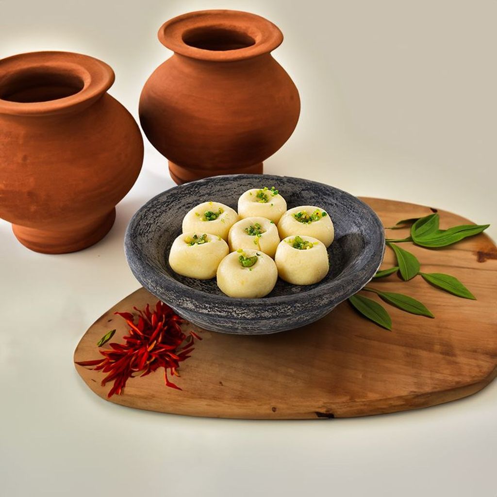 Doodh Peda dessert showcasing a soft, creamy milk sweet with a light garnish of cardamom.