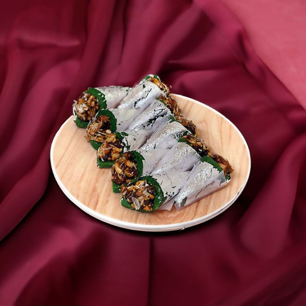 Pista Pan dessert showcasing a delicate fusion of pistachio and paan flavors with a garnish of crushed pistachios.