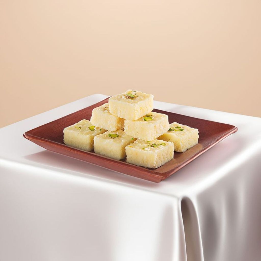  white kalakand with pistachio topping served on a tray