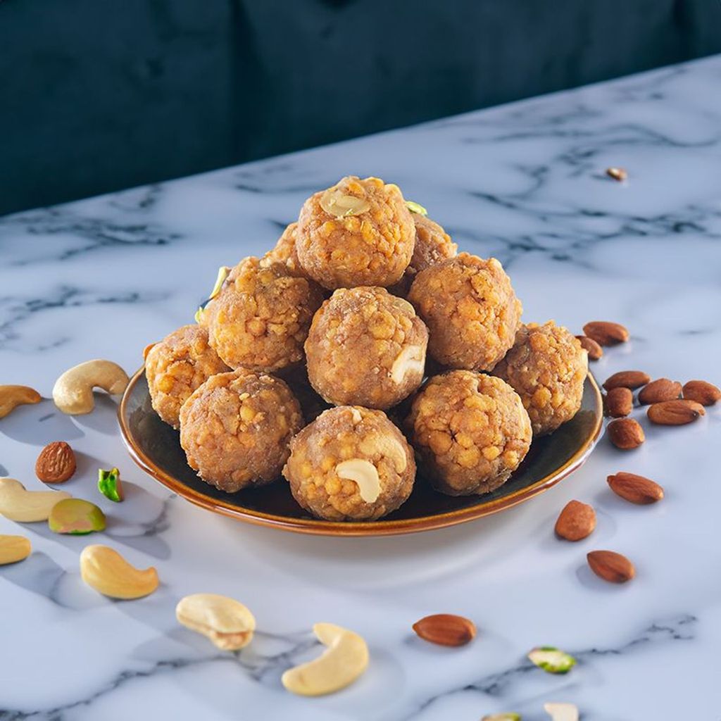 traditional indian sweet tirupati laddu stacked inside a plate.