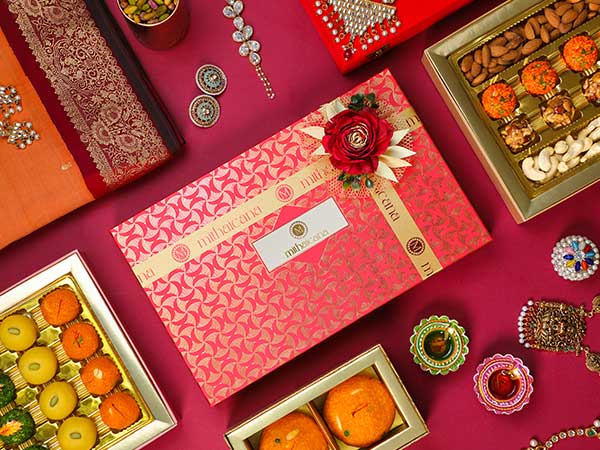 indian wedding sweet boxes wrapped in decorative cellophane and tied with ribbons.