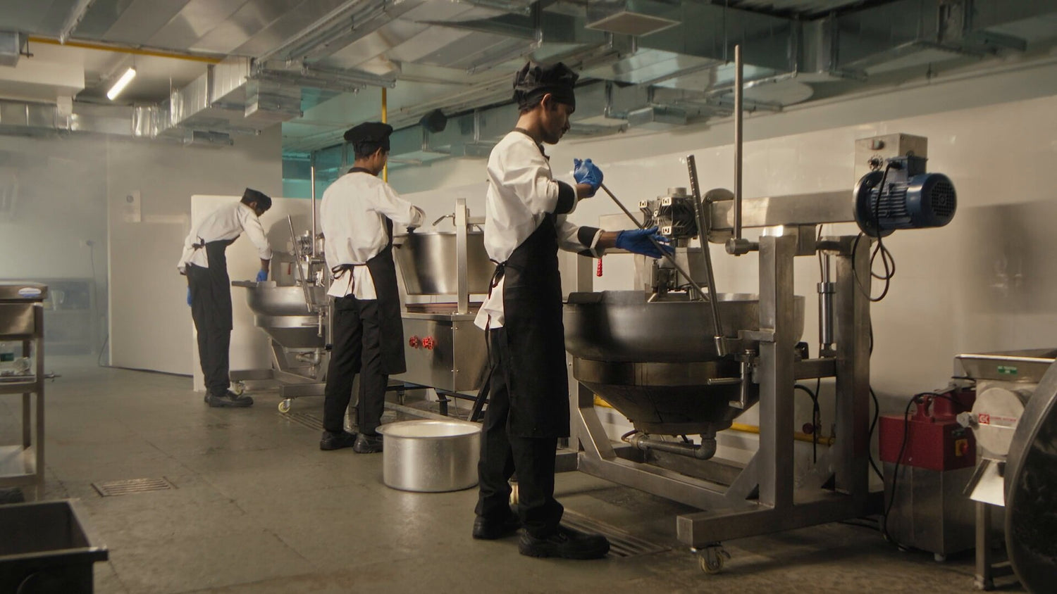 interior of mithaicana commercial kitchen and chefs preparing sweets