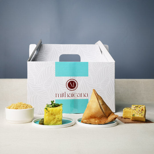 mithaicana snack gift box containing dhoklas, soan papdi, and namkeen