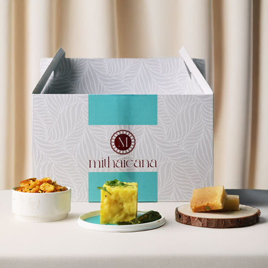 mithaicana snack box with namkeen, barfi, and dhokla