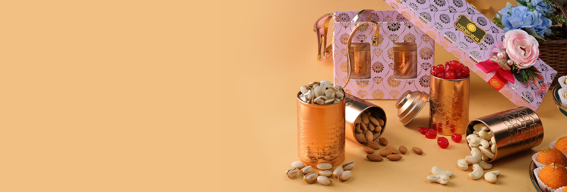 mixed nuts displayed in decorative copper bowls besides a personalized gifting box.