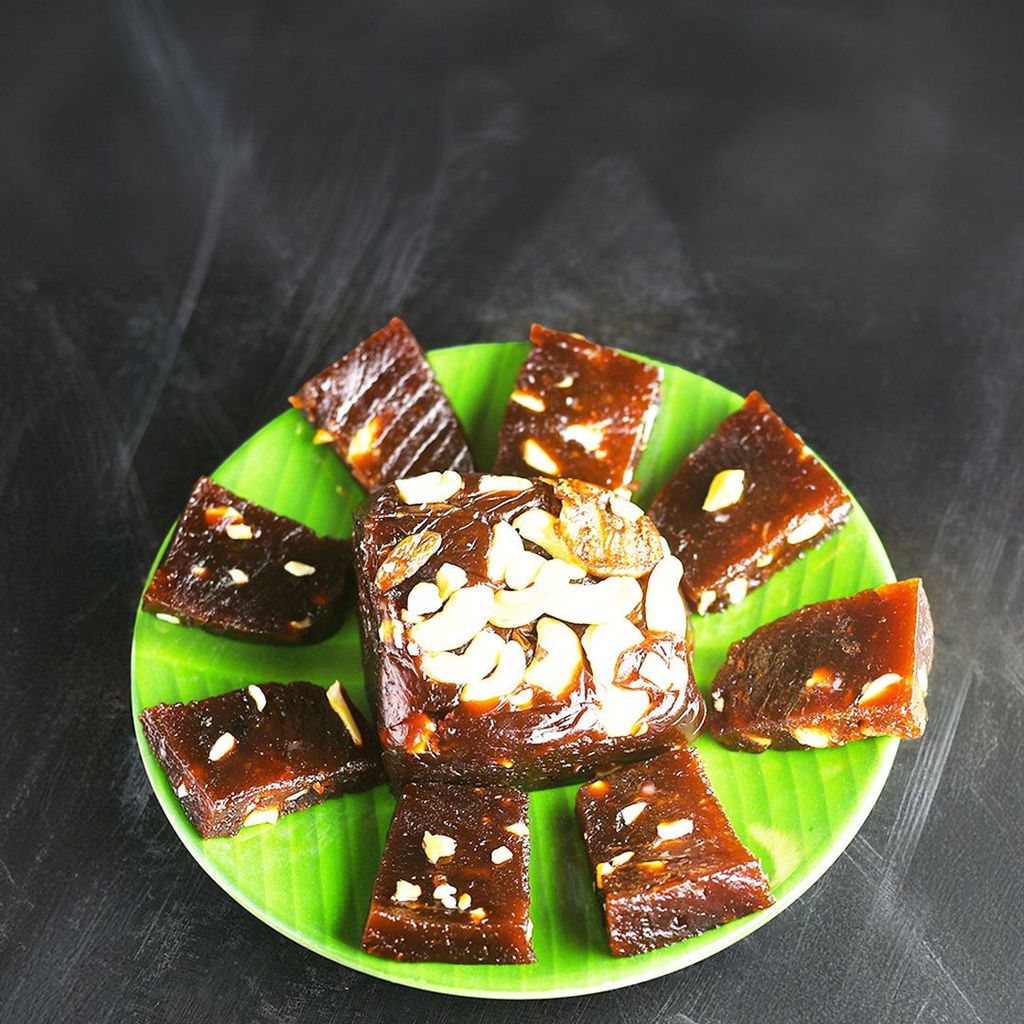 Rich and chewy Bandar Halwa, a beloved Andhra sweet, served on a decorative green leaf plate.