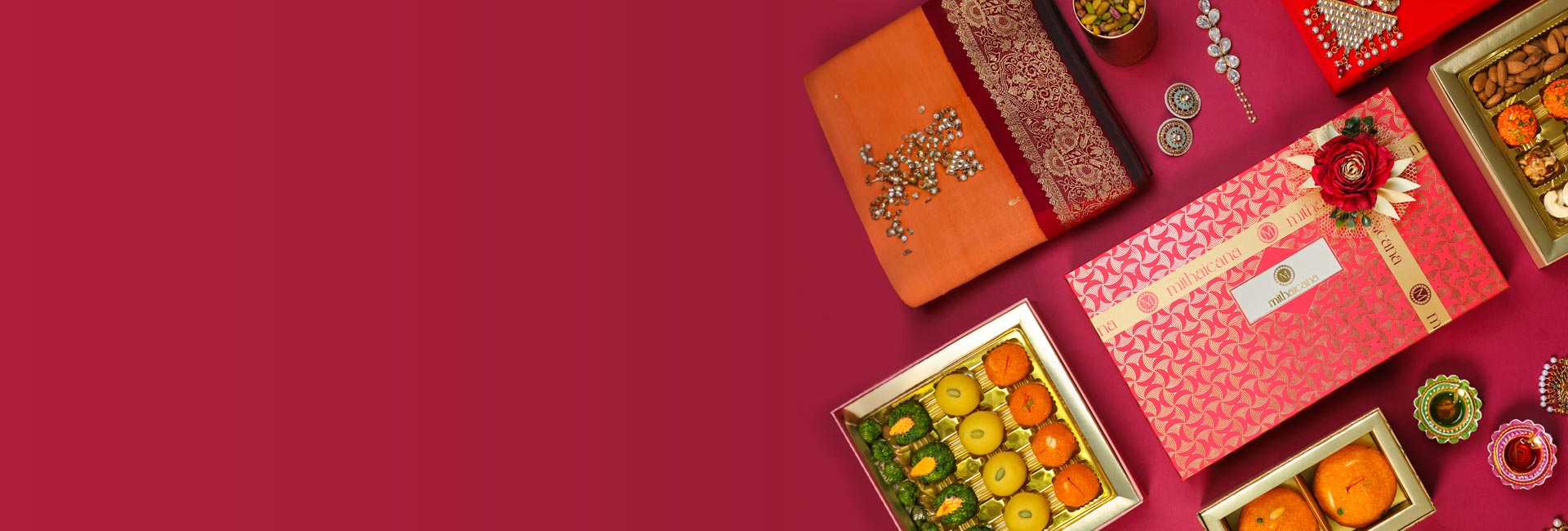 assorted Indian sweets for festive occasions on a maroon background